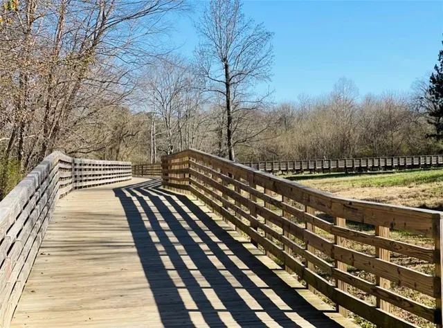 a view of a lake with lots of flowers and around