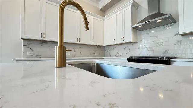 a kitchen with stainless steel appliances granite countertop a sink a stove and a granite counter tops