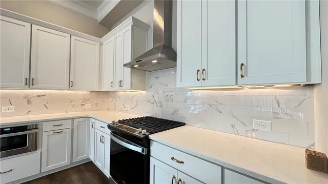a kitchen with granite countertop white cabinets and white appliances