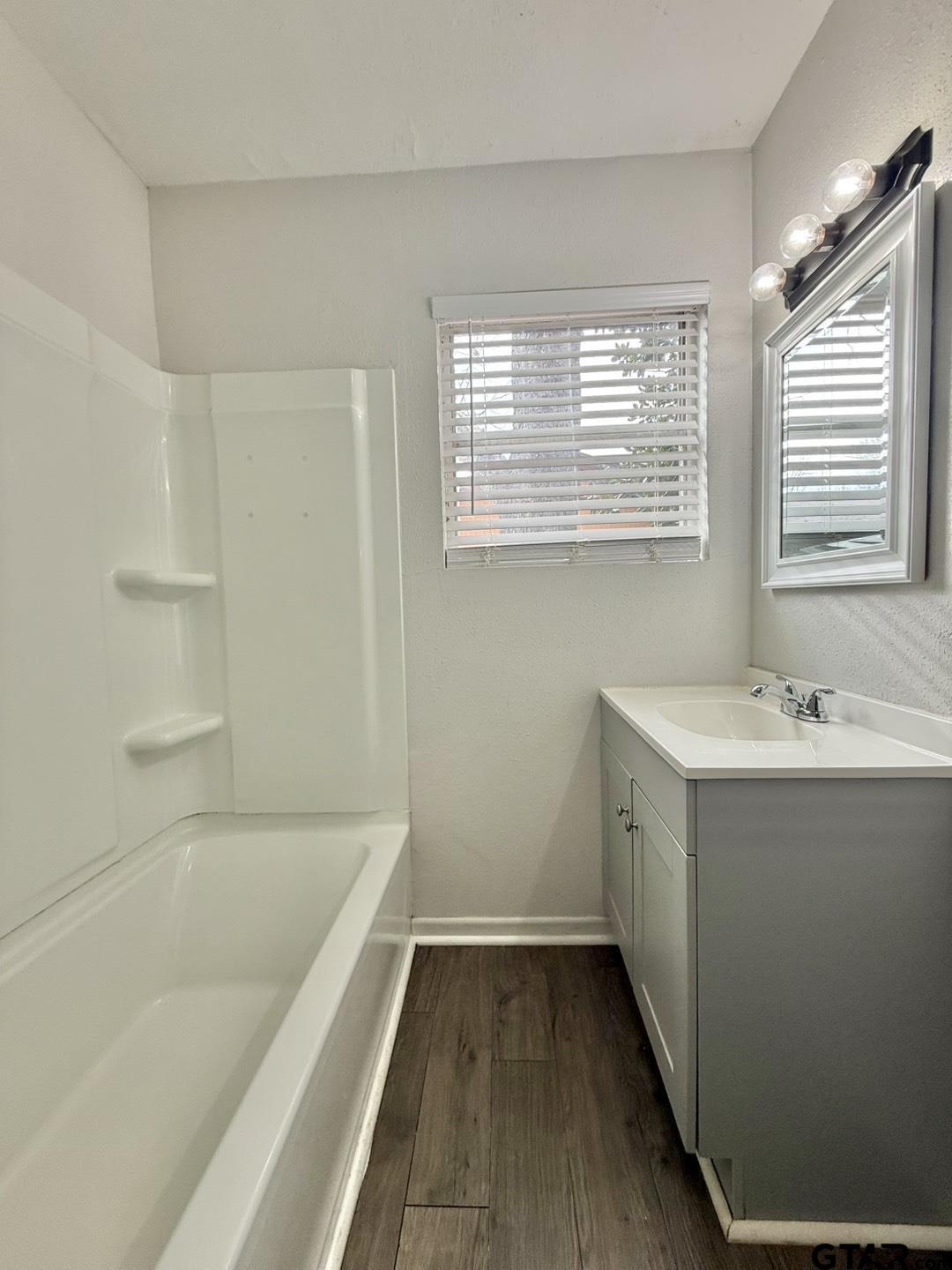 533 Bandera Drive Tyler, TX 75702 - Photo 14 of 18 a bathroom with a bathtub and a sink