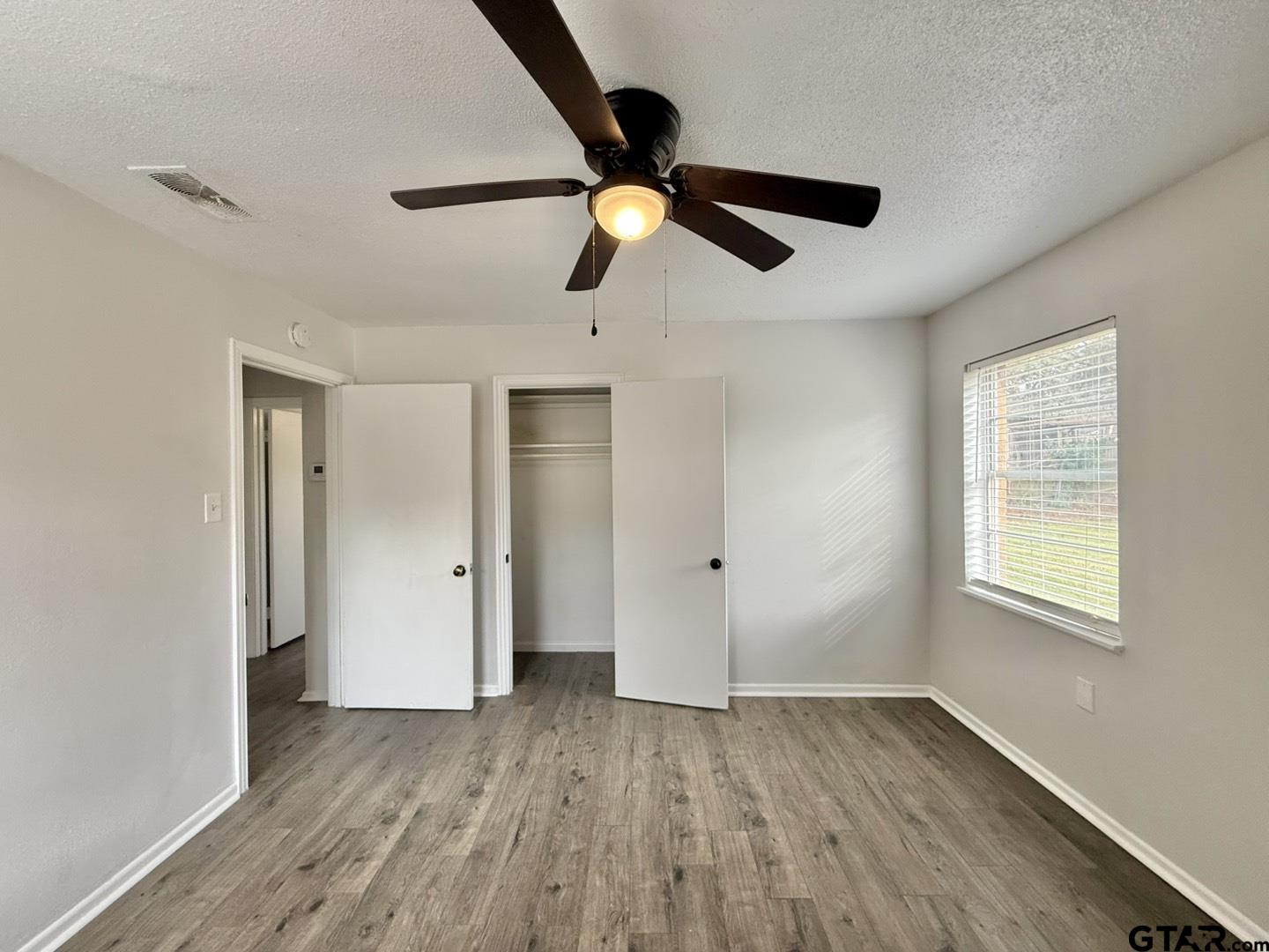 533 Bandera Drive Tyler, TX 75702 - Photo 16 of 18 a view of empty room with wooden floor and window
