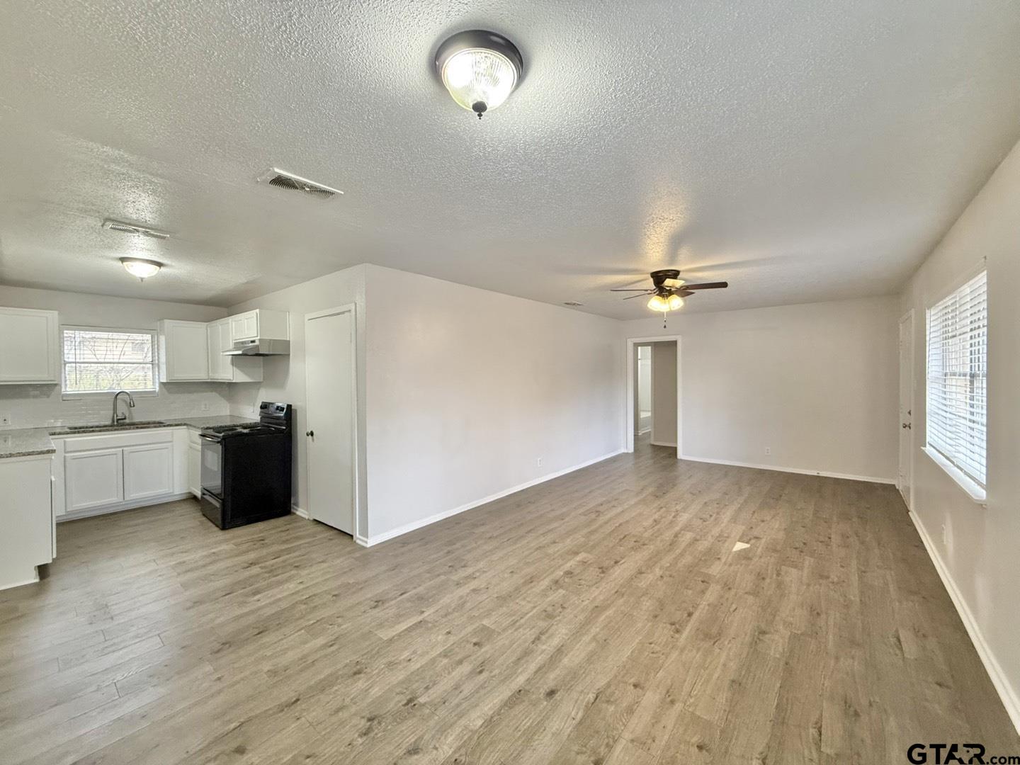 533 Bandera Drive Tyler, TX 75702 - Photo 5 of 18 a view of a kitchen with a sink and a refrigerator