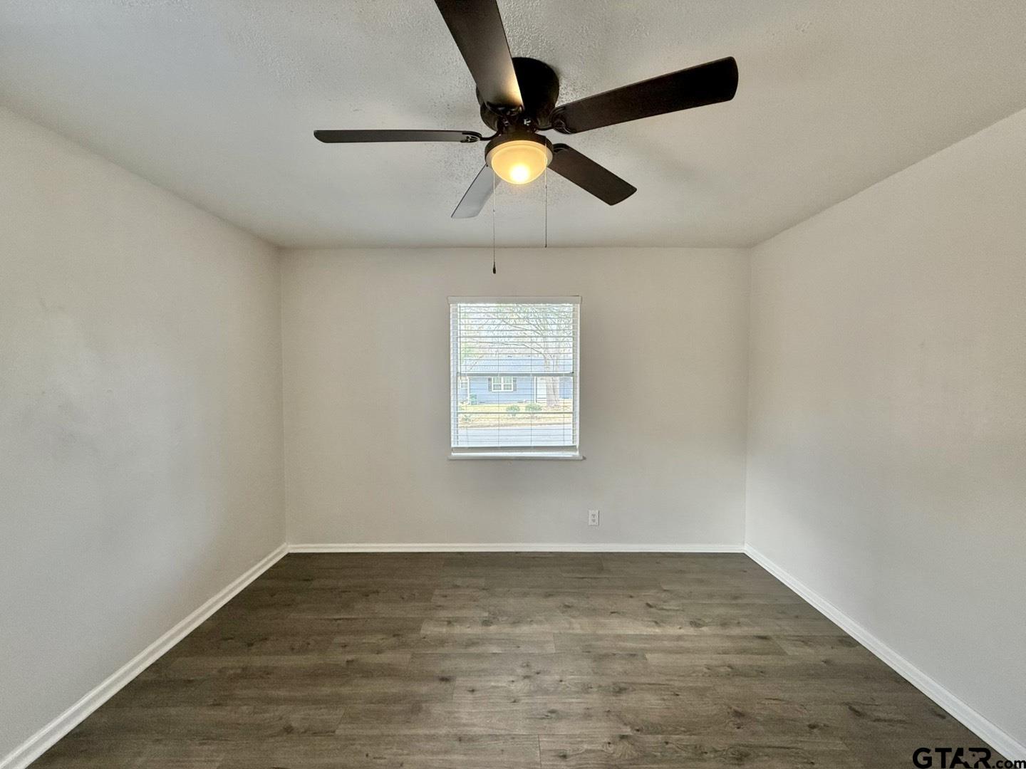 533 Bandera Drive Tyler, TX 75702 - Photo 10 of 18 an empty room with wooden floor and windows