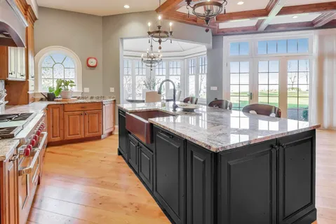 a spacious bathroom with a granite countertop tub sink and mirror