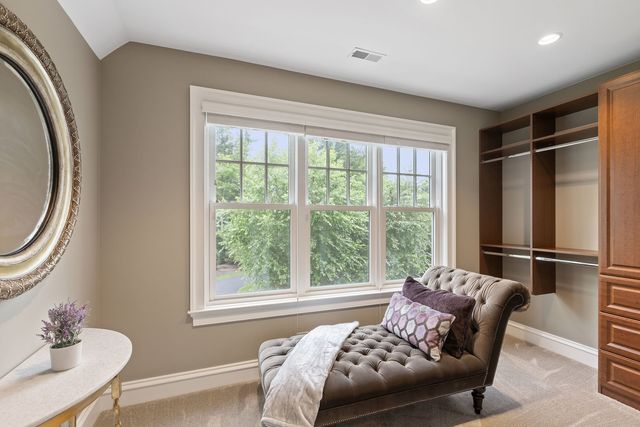 a view of swimming pool with seating area and trees