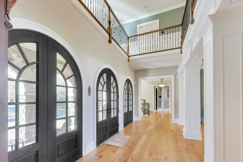 a view of a dining room with furniture wooden floor and chandelier