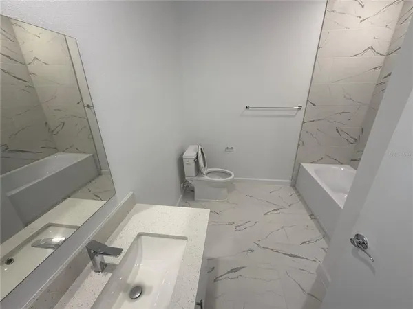 a bathroom with a sink and shower