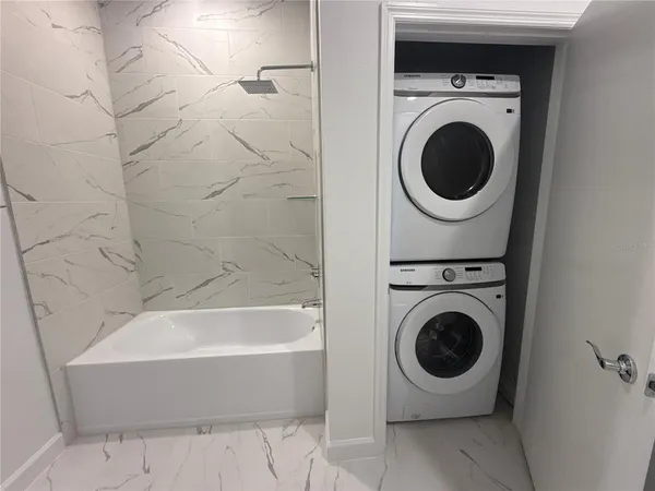 a bathroom with a sink and a washer dryer