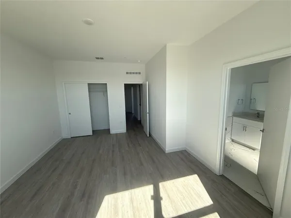 a view of hallway with wooden floor