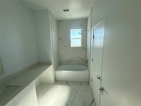 a bathroom with a bathtub and shower