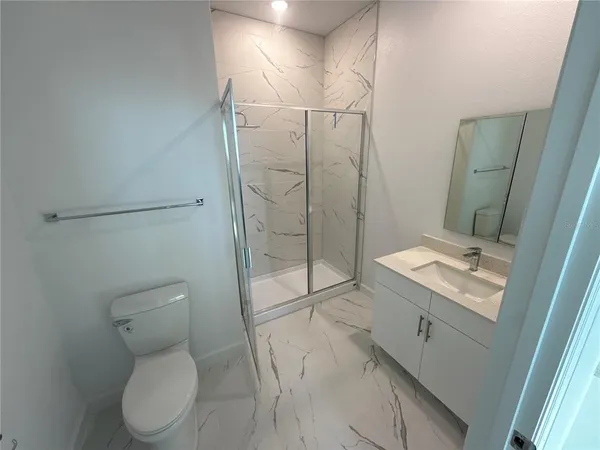 a bathroom with a toilet sink and shower