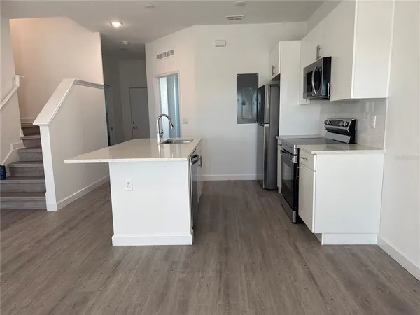 a room with cabinets and wooden floor