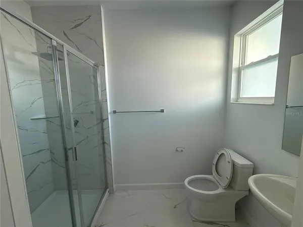 a bathroom with a toilet and shower
