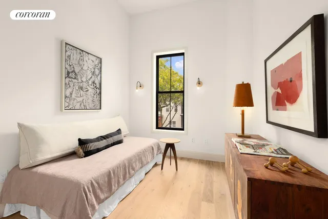 a bedroom with furniture and a window