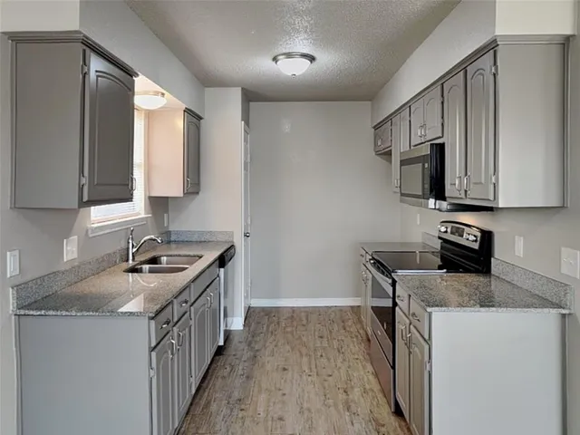 a kitchen that has a sink and a stove