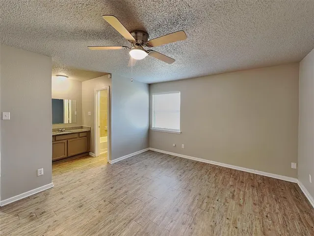 a view of a kitchen with a sink and a refrigerator