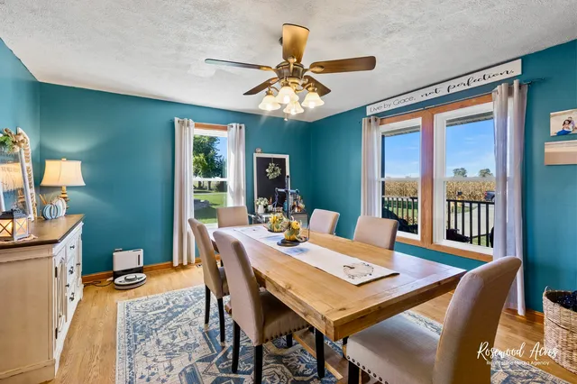 a view of a dining room with furniture a chandelier and wooden floor