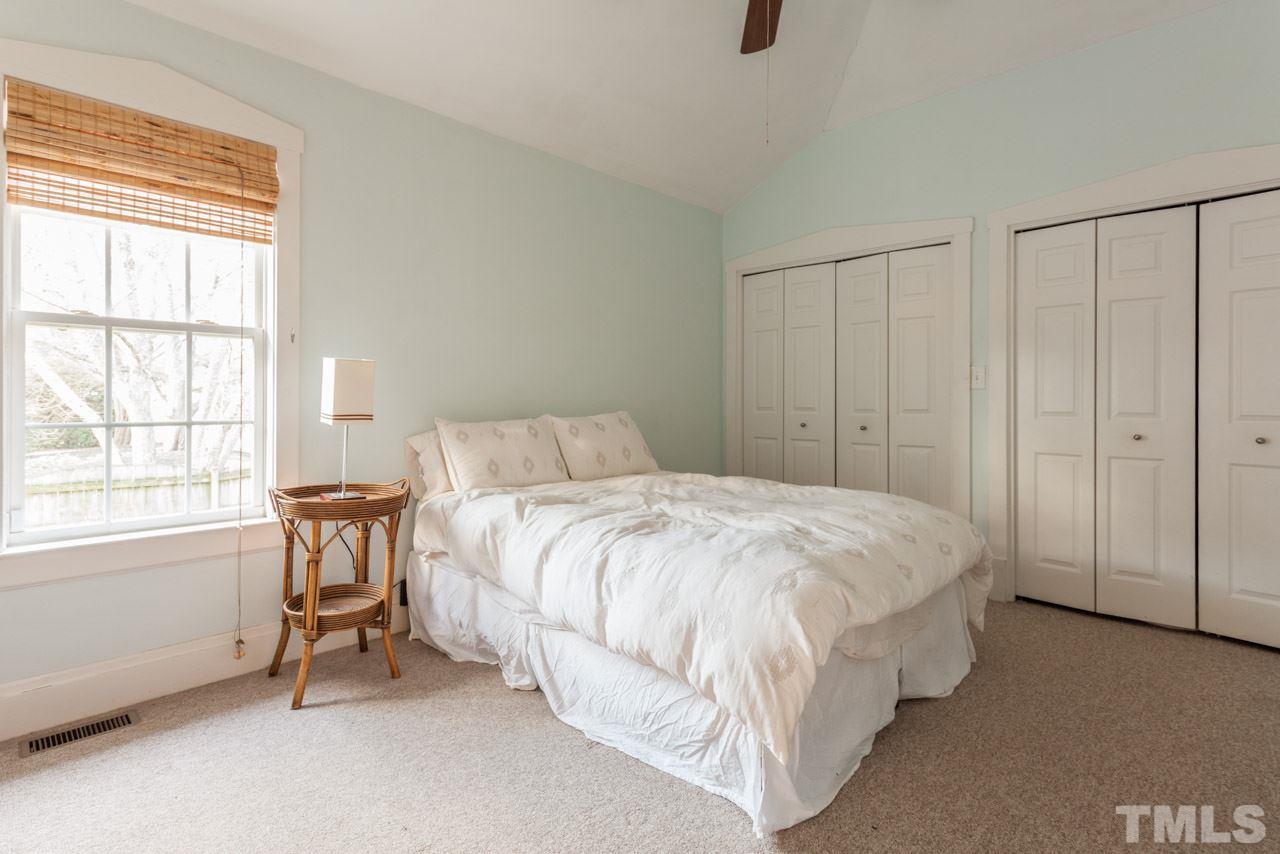 500 Frank Street Raleigh, NC 27604 - Photo 15 of 23 a spacious bedroom with a bed and a table in it
