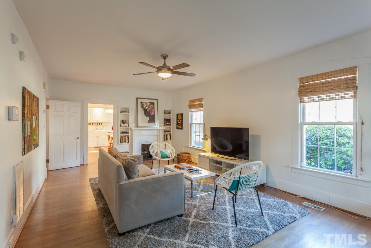 500 Frank Street Raleigh, NC 27604 - Photo 3 of 23 a living room with furniture a flat screen tv and a window