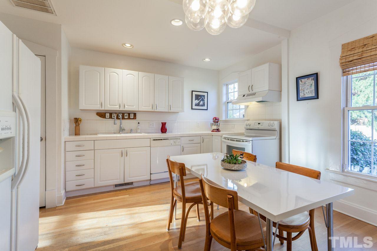 500 Frank Street Raleigh, NC 27604 - Photo 5 of 23 a kitchen with stainless steel appliances a dining table chairs and window