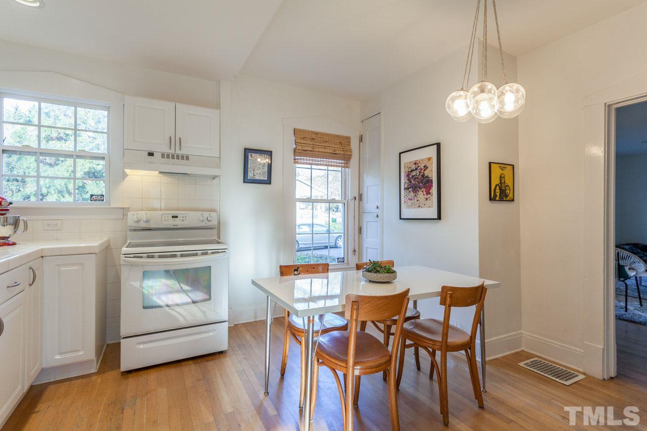500 Frank Street Raleigh, NC 27604 - Photo 6 of 23 a dining room with wooden floor a chandelier a wooden table and chairs