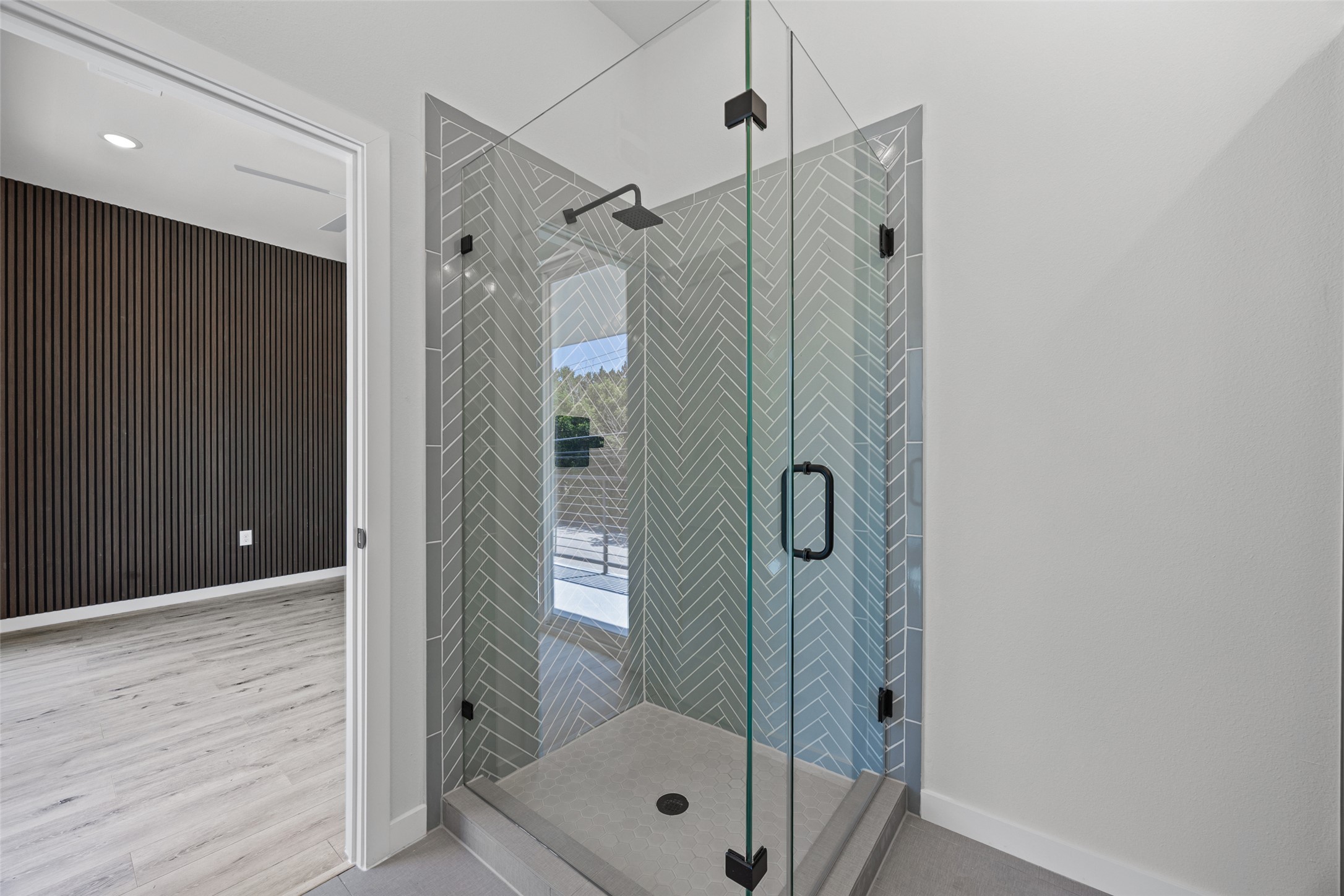 2000 Riverside Farms Road, Unit 5102 Austin, TX 78741 - Photo 22 of 25 A modern glass-enclosed shower features chic chevron-patterned tile and sleek matte black fixtures.