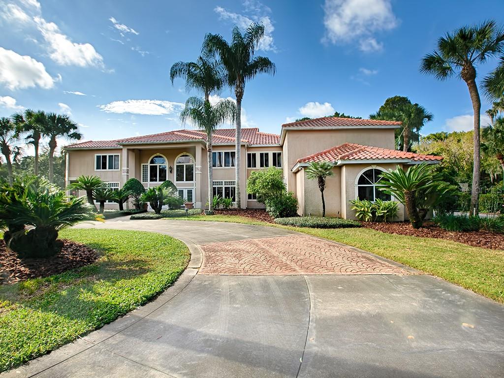 11410 Lane Park Road Tavares, FL 32778 - Photo 1 of 1 Exterior Front, circular drive. Brand new tile Roof!