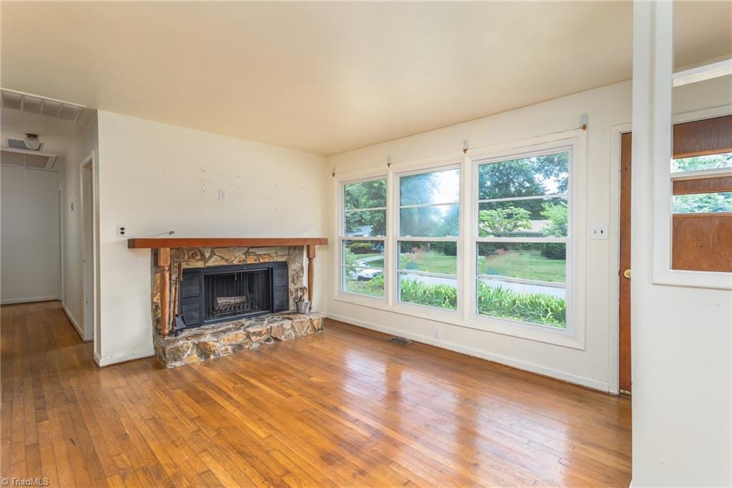 308 Melbourne Road Greensboro, NC 27405 - Photo 5 of 22 Living room with large windows and wood floors