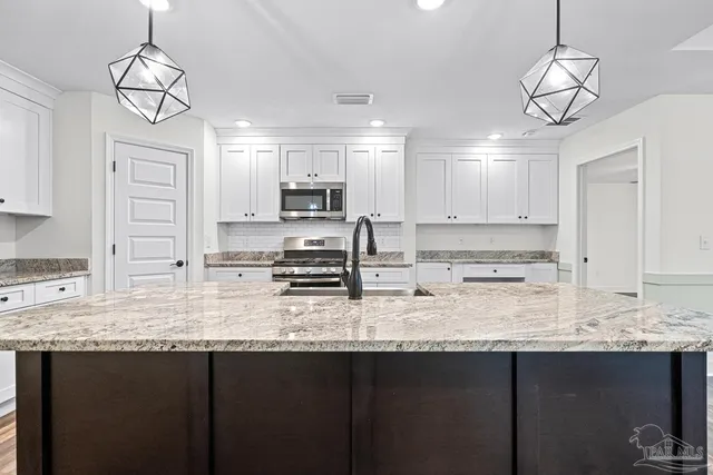 a kitchen with a sink and chandelier