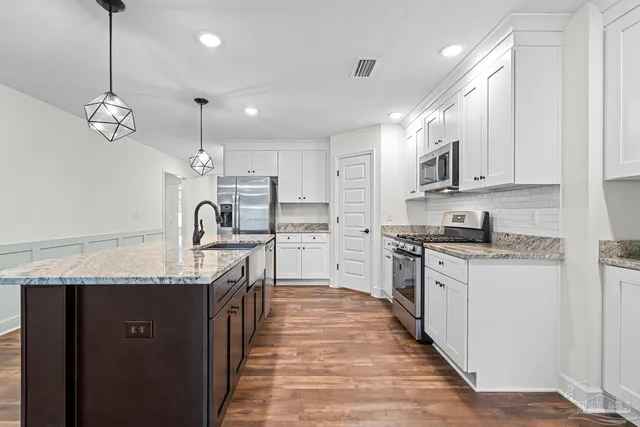 a view of a livingroom with wooden floor and a fireplace