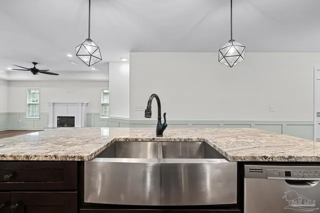 a view of empty room with wooden floor and ceiling fan
