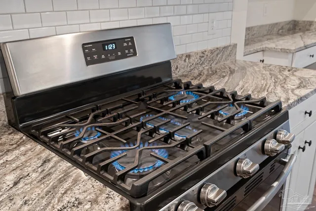 a view of empty room with wooden floor and window
