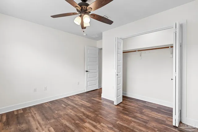 a bathroom with a granite countertop sink a toilet and a bathtub