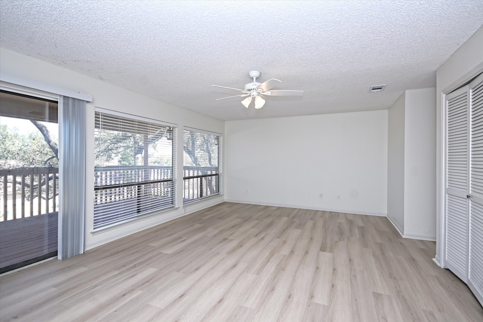 105 Crescent Bluff Austin, TX 78734 - Photo 15 of 28 wooden floor in an empty room with a window