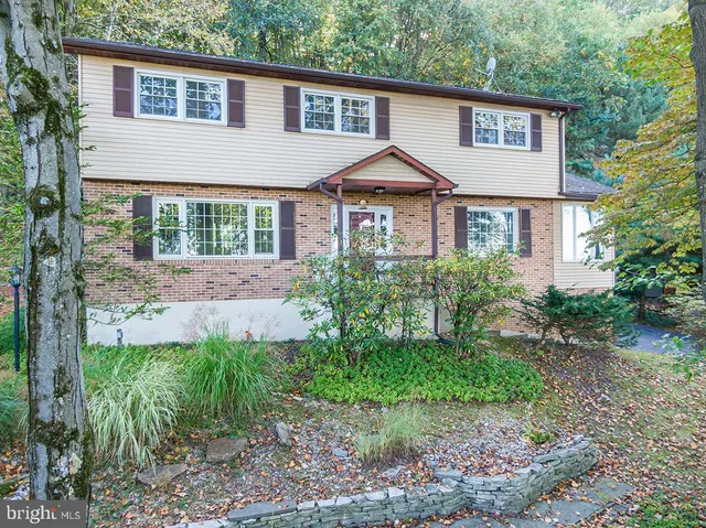 a front view of a house with a yard and porch