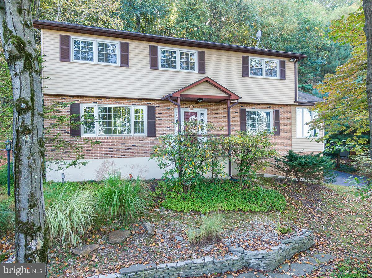 a front view of a house with a yard and porch