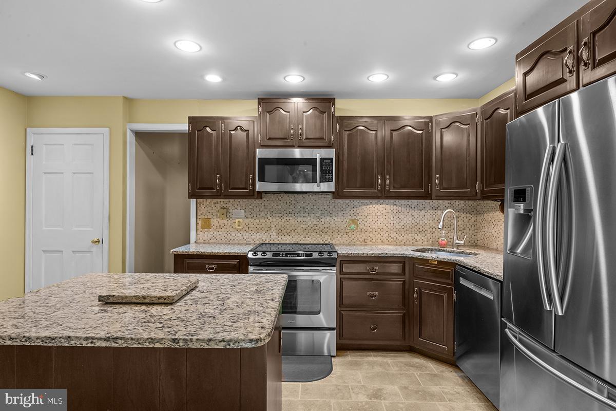 310 4th Street Reading, PA 19607 - Photo 14 of 44 a kitchen with stainless steel appliances granite countertop a sink stove and refrigerator