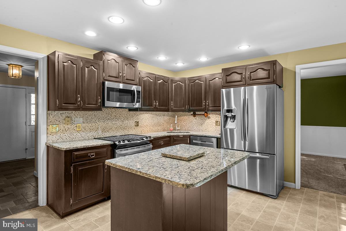 310 4th Street Reading, PA 19607 - Photo 15 of 44 a kitchen with granite countertop a refrigerator and a sink