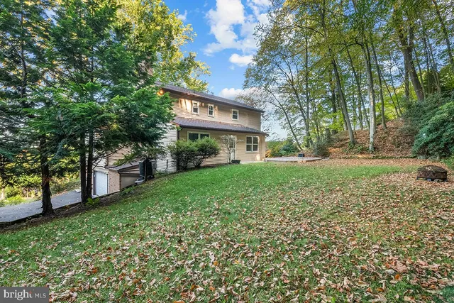a view of a house with a yard and tree s