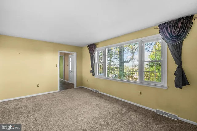 a view of an empty room and a window