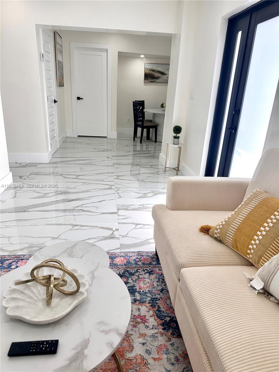 237 Northeast 110th Terrace, Unit 237 Miami, FL 33161 - Photo 4 of 12 a living room with furniture and a table