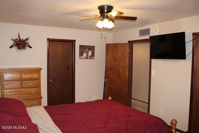 1201 East Old Stewart Road Willcox, AZ 85643 - Photo 37 of 49 a bedroom with a bed and a chandelier