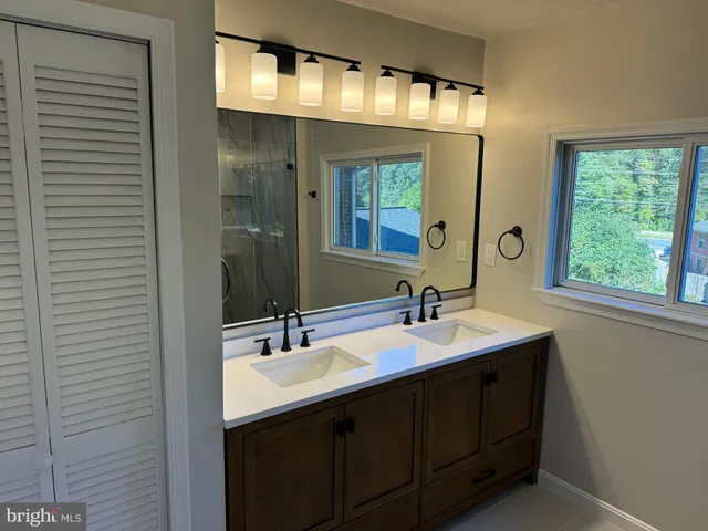 a bathroom with a sink double vanity and a mirror