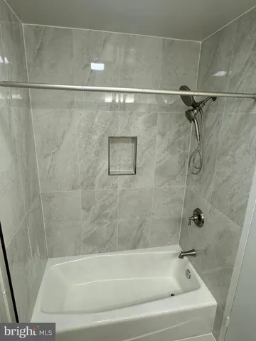 a bathroom with a shower and a bath tub