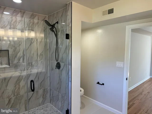 a bathroom with a shower and a tub