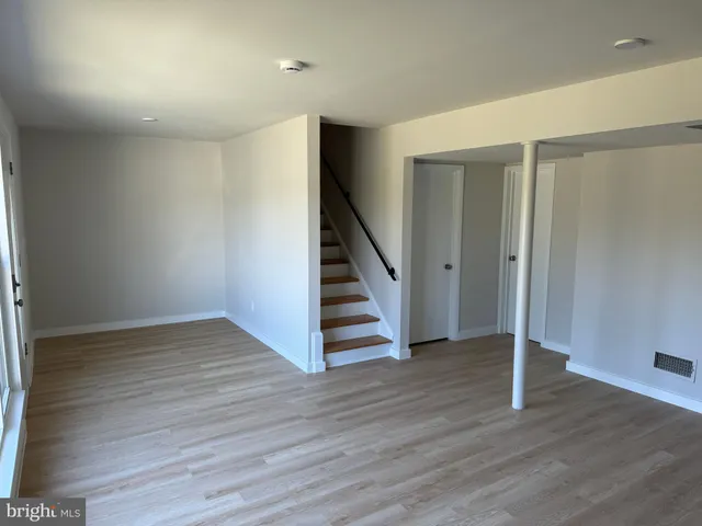 a view of a hallway with wooden floor and entryway