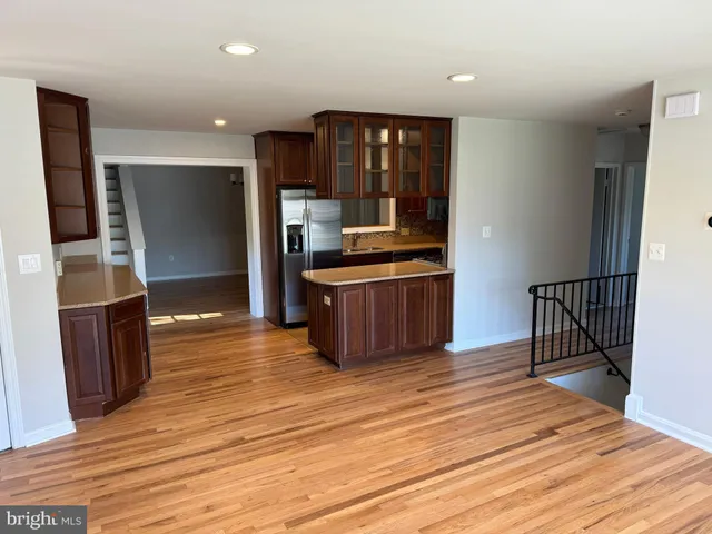 a kitchen with stainless steel appliances wooden floor and cabinets
