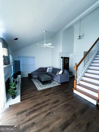 a living room with furniture and wooden floor