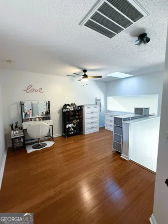 a view of a livingroom with furniture and a ceiling fan