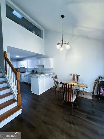 a view of a dining room with furniture wooden floor and a chandelier